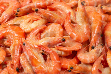 Shrimps background texture. A lot of shrimps. Cooked shrimps.