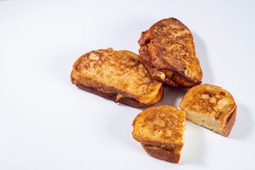Fried bread with milk, egg, sugar, cinnamon and filled with cream (Torrijas). Typical Spanish Easter sweet. Horizontal photography and selective focus