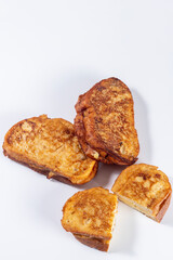 Fried bread with milk, egg, sugar, cinnamon and filled with cream (Torrijas). Typical Spanish Easter sweet. Vertical photography and selective focus