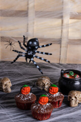halloween cupcake, chocolate, blue and black battercream and gumdrop pumpkin. Vertical shot and selective focus