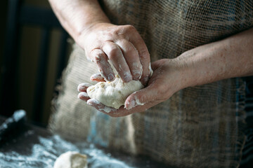 close-up view of hands making delicious pies with dough