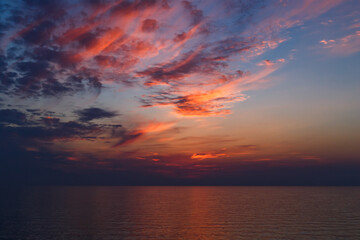 A stunning pink and orange sunset sky in the middle of Mediterranean sea, sunset background.