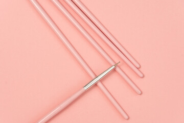 cosmetic flat lay: pink makeup brushes on pink background