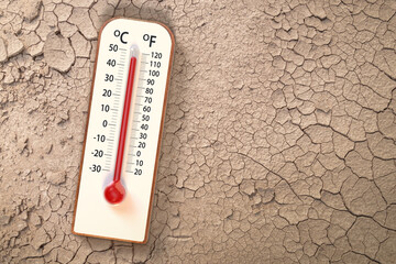 Top view Thermometer on Dry soil ground cracks background texture show higher Weather, concept...