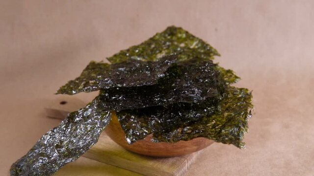 Japanese food nori dry seaweed or edible seaweed close-up. slow motion
