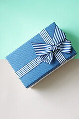 Gift box on a light background with a blue cover, holiday concept.