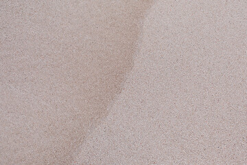 Fototapeta premium the texture of the sand on the beach is wet from the wave. natural background