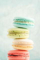 heap of colorful macaroons over green background with copy space