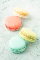 colorful macaroons on green background with copy space