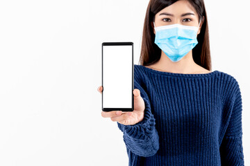 Blurred soft images of Asian attractive woman wearing a surgical mask Holding and show mobile phone On white background, to people health care and technology concept.