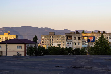 Obraz premium Multi-storey residential Soviet panel houses against the backdrop of mountains.