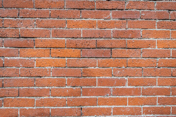 Obraz premium Close up of a red brick wall background