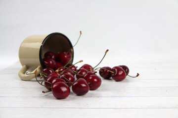 a metall mug of black cherry lying on white background