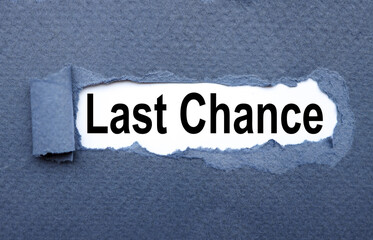LAST CHANCE. text on torn cardboard. black letters on white paper