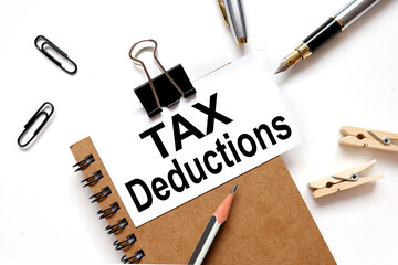 tax deductions. the inscription on the business card is attached to the notebook.