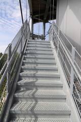 a galvanized steel staircase with railing