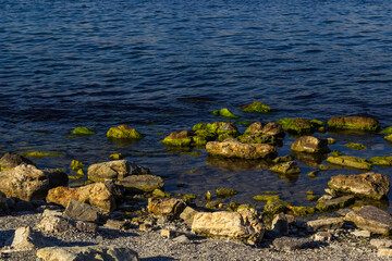 Rocky seaside. Sharp large stones on the seashore.