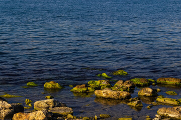 Rocky seaside. Sharp large stones on the seashore.