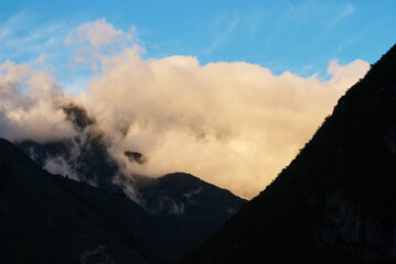 Mountain peak, clouds and sky.