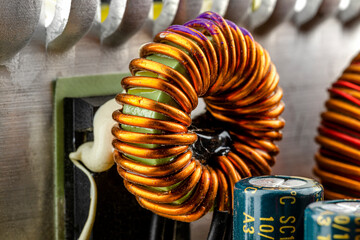 An inductor, toroidal coil on a ring with visible copper scroll, wound on a magnetic coil.