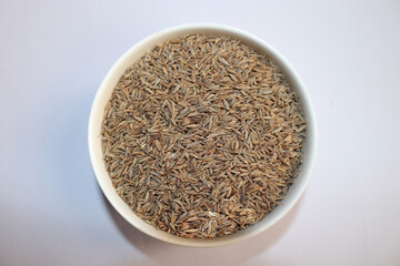 Caraway or carvi seeds  on white background.