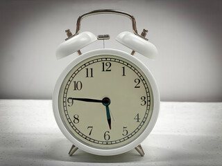 White classic style alarm clock isolated on white background. 