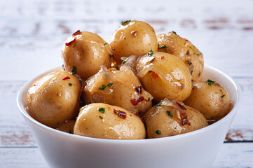 Homemade mini pickled potatoes in a white bowl