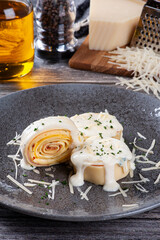 .Ham and cheese rondelli topped with white parmesan sauce