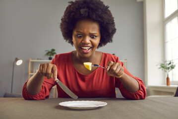 Unhappy frustrated african american woman weight loss on diet headshot portrait. Young hungry black...