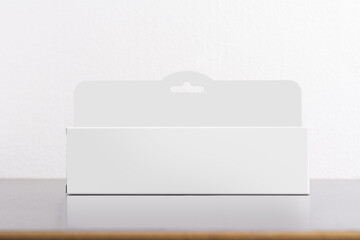 Rectangular box package mockup with a hanger on the table