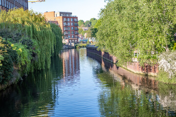 Fototapeta na wymiar A view down the RIver Wensum in the city of Norwich. Captured on a bright and sunny evening