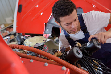 Fototapeta na wymiar auto mechanic fixing an engine