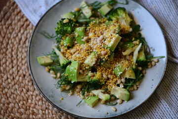 vegetarian healthy, fresh, green salad of broccoli, avocado and micro-greens with pine nuts in mustard-orange sauce. 