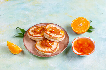 Fototapeta na wymiar Homemade american pancakes with orange fruits.