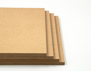 Four raw mdf boards are brown wooden boards photographed on a white background.