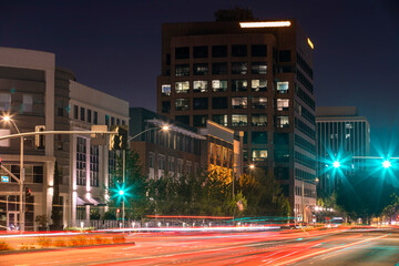 Night time view of traffic passing through Harbor Boulevard in downtown Anaheim, California, USA.