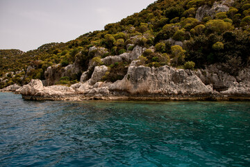 Fototapeta na wymiar magnificent view of rocks with green trees and clear turquoise water of the Mediterranean Sea