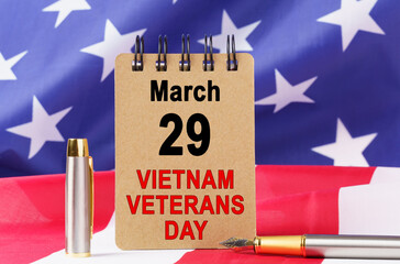 Against the background of the US flag lies cardboard with the inscription - VIETNAM VETERANS DAY