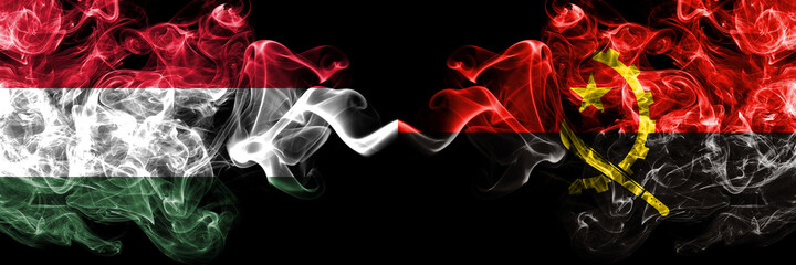 Hungary, Hungarian vs Angola, Angolan smoky flags side by side.
