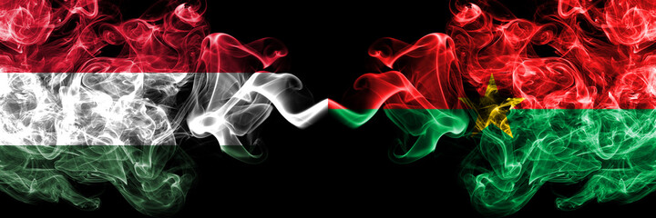 Hungary, Hungarian vs Burkina Faso, Burkinese smoky flags side by side.