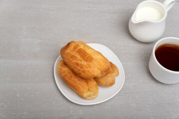 Homemade cakes for tea. Profiteroles or puffs, popovers or eclaires.
