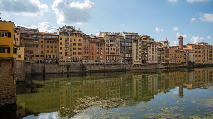 Fototapeta na wymiar Buidings at Ponte Vecchio landmark reflected on arno river. Florence, Tuscany Italy.