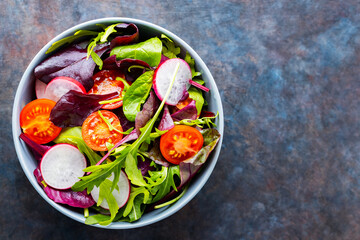 Salad with cherry tomatoes, radish and mix salad. Healthy salad, leaves mix salad. Paleo diet concept. Copy space. Top view