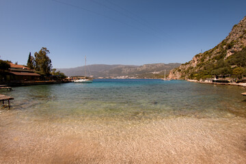 great view from shore to clear transparent turquoise water of sea bay and mountains landscape