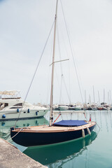 Fototapeta na wymiar Yacht parking in harbor. White sailing yachts at the pier. Sea yacht club. Aegean sea. Athens, Greece. Blue sky.