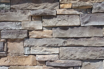 Wall of oblong Tan and Brown Stones