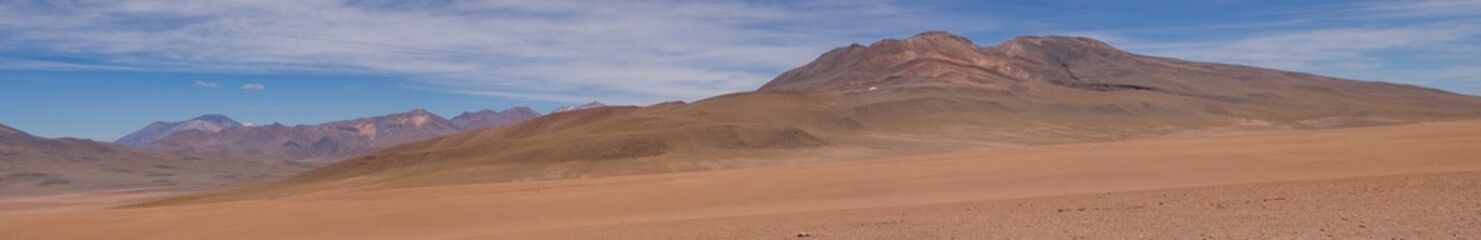 Huge panorama landscape in desert of brown and orange mountains in deserto de atacama, chile
