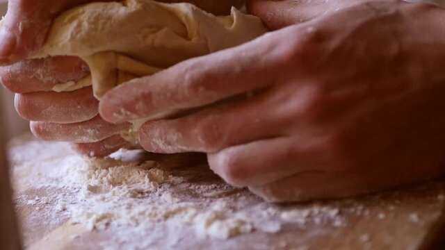 Close up kneading dough by hands. Handmade baking process. 4k video