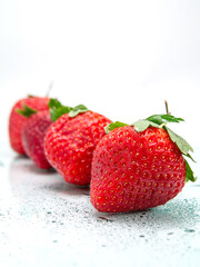 Red juicy strawberry with water droplets on a white background. Produce product