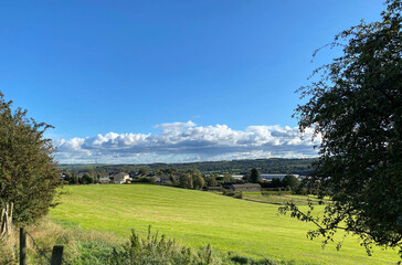 Rural landscape, with sloping fields, farmhouses, and distant trees near, Cleckheaton, Bradford, UK